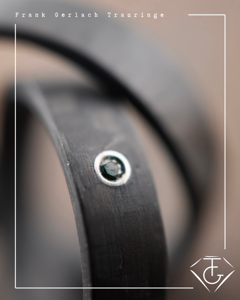 Preview: Trauringe aus Carbon mit glatter Oberfläche und blauem Diamant